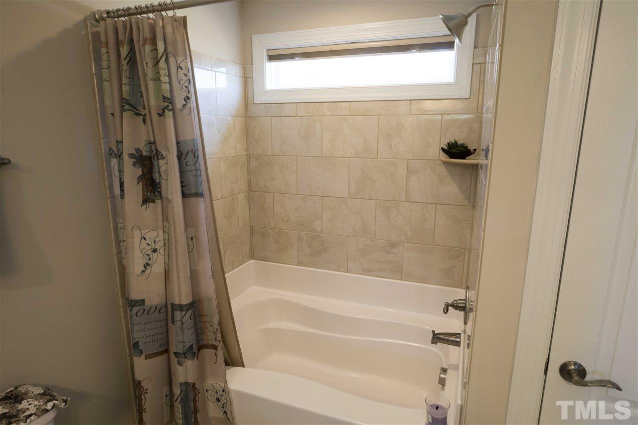 1309 Silver Farm Road Raleigh, NC 27603 - Photo 18 of 24 a bathroom with a bathtub and a shower