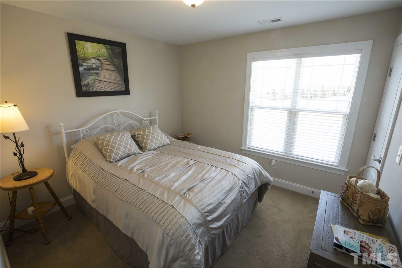1309 Silver Farm Road Raleigh, NC 27603 - Photo 19 of 24 a bedroom with a bed and wooden floor