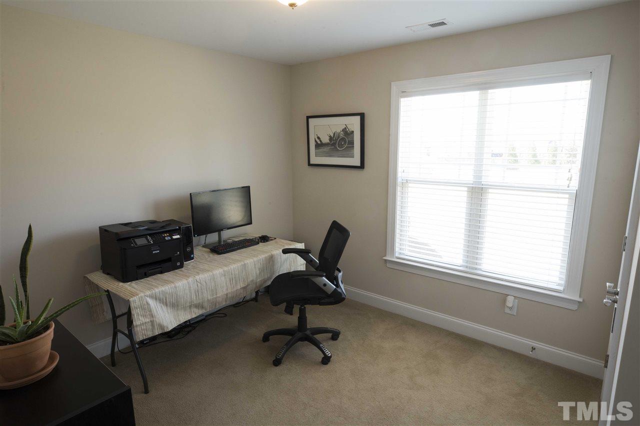 1309 Silver Farm Road Raleigh, NC 27603 - Photo 20 of 24 a view of a workspace with furniture and a window