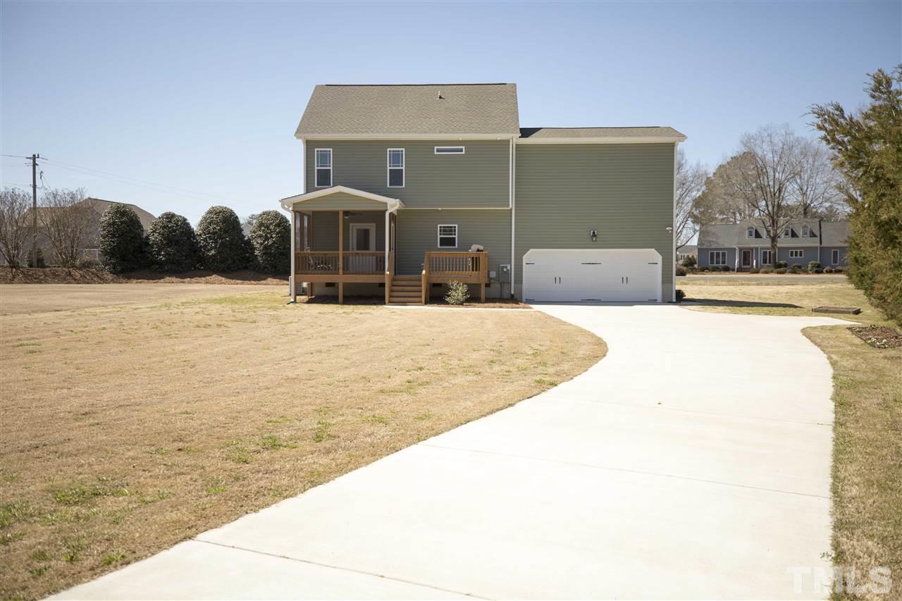 1309 Silver Farm Road Raleigh, NC 27603 - Photo 23 of 24 a view of a house next to a lake with a mountain