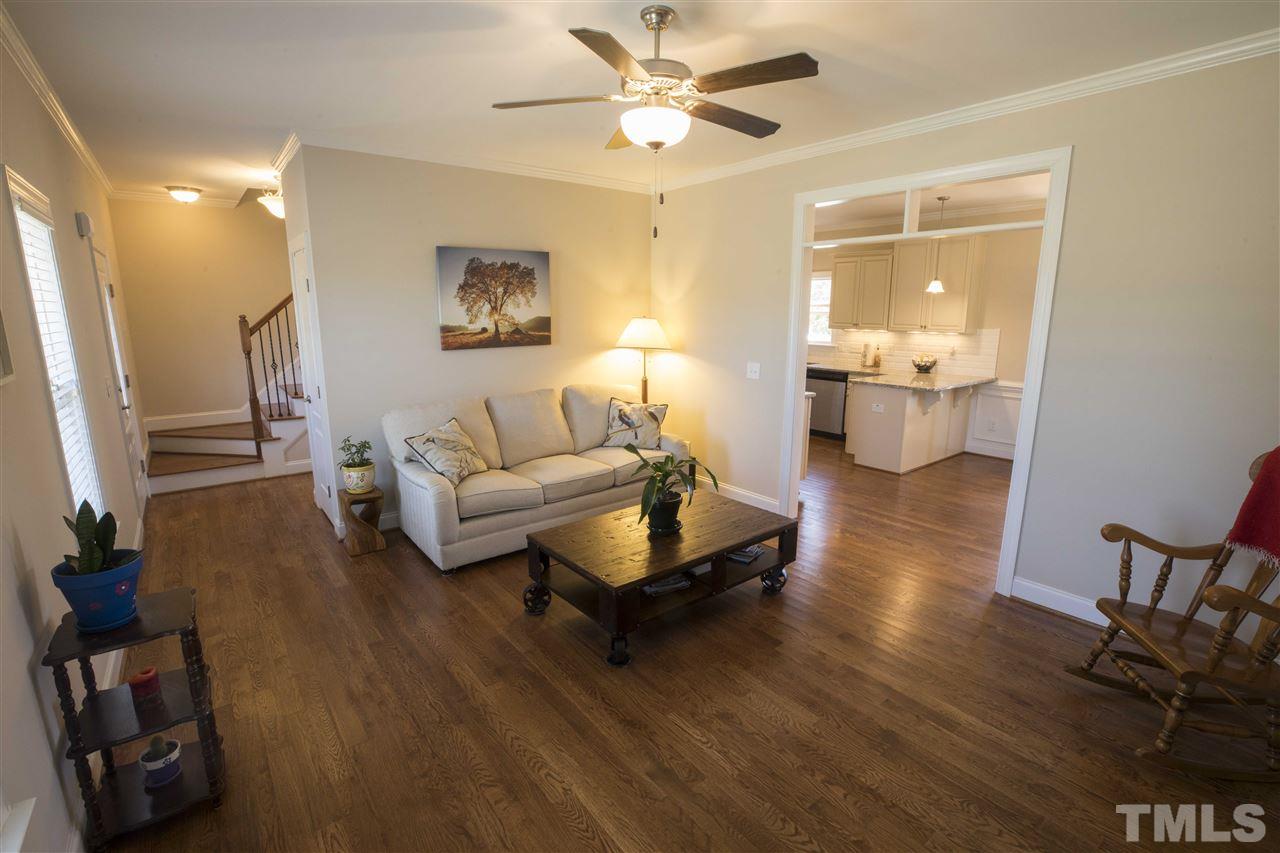 1309 Silver Farm Road Raleigh, NC 27603 - Photo 4 of 24 a living room with furniture and a wooden floor