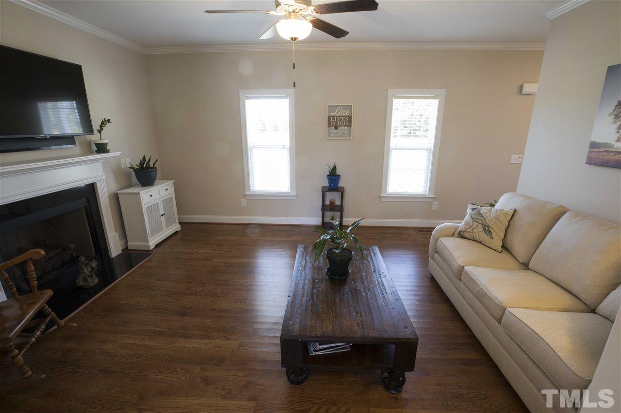 1309 Silver Farm Road Raleigh, NC 27603 - Photo 5 of 24 a living room with furniture and a fireplace