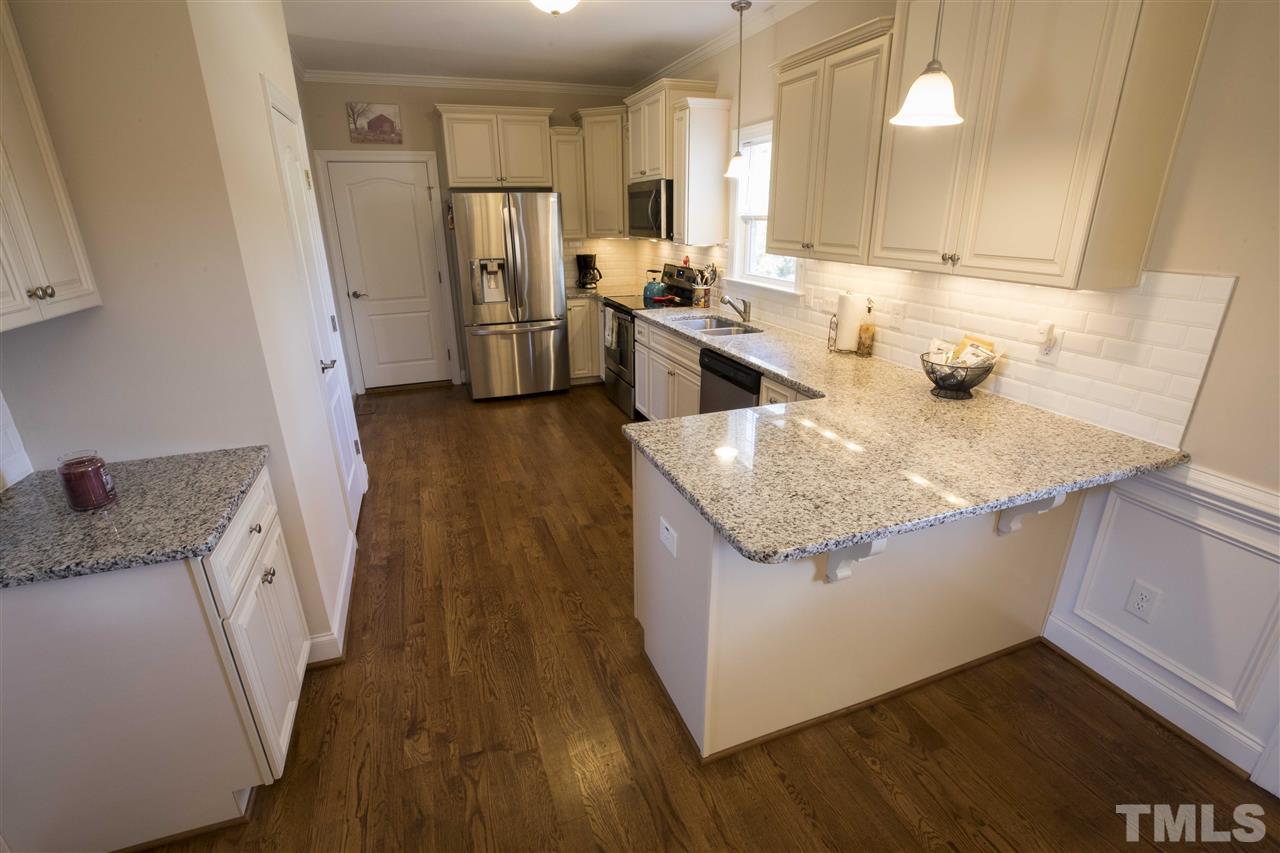 1309 Silver Farm Road Raleigh, NC 27603 - Photo 8 of 24 a kitchen with sink and refrigerator