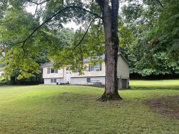 a view of a trees with backyard of house