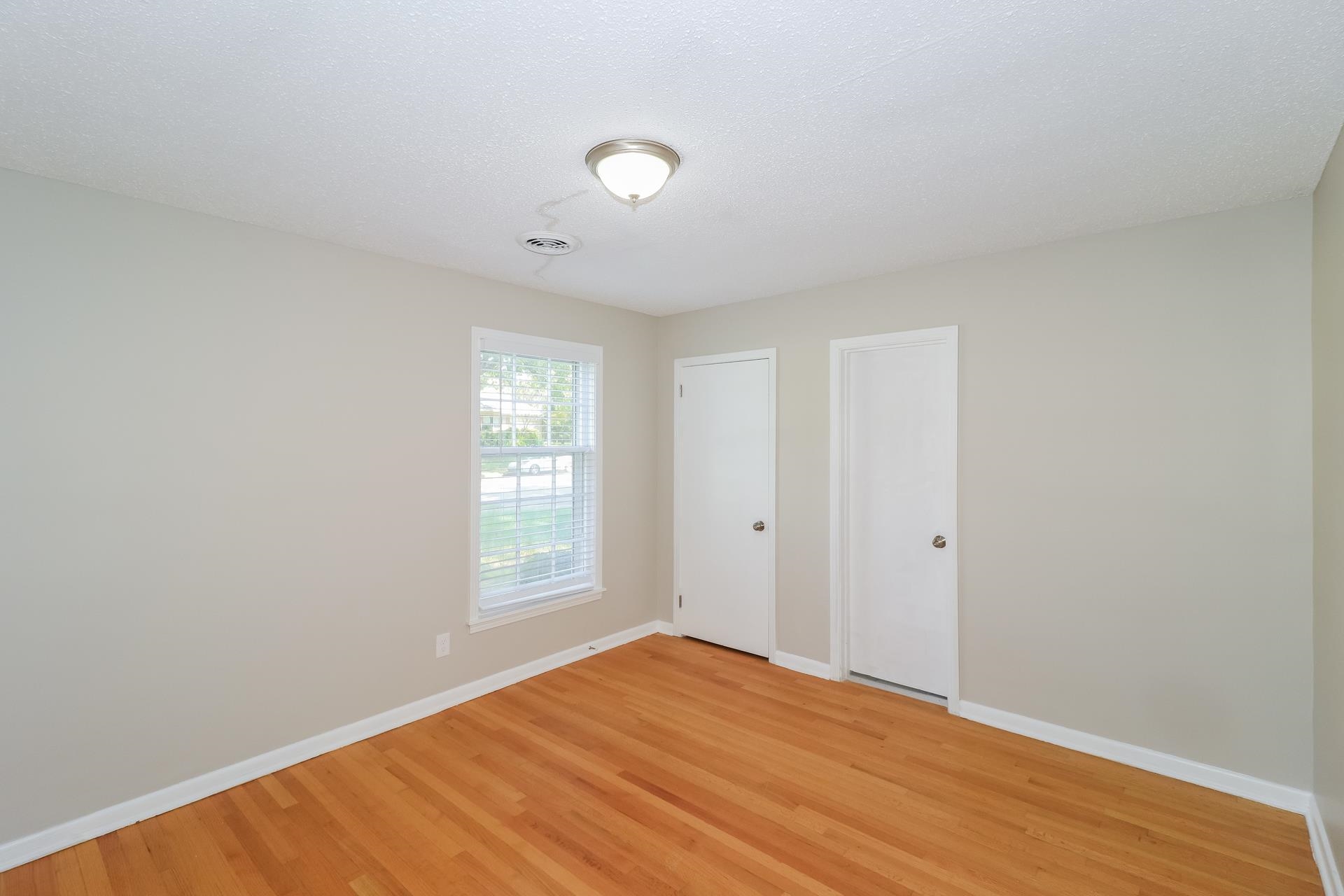 4947 Dee Road Memphis, TN 38117 - Photo 14 of 15 a view of empty room with wooden floor and fan