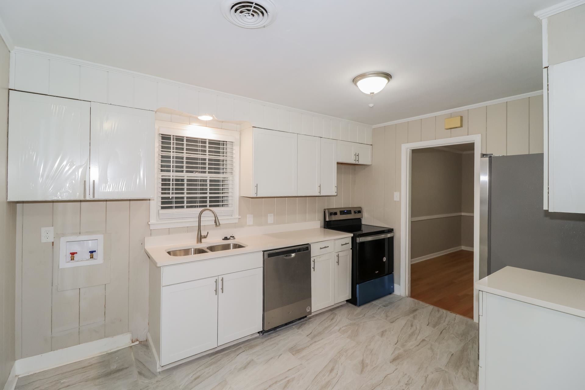 4947 Dee Road Memphis, TN 38117 - Photo 5 of 15 a kitchen with a sink a refrigerator and window