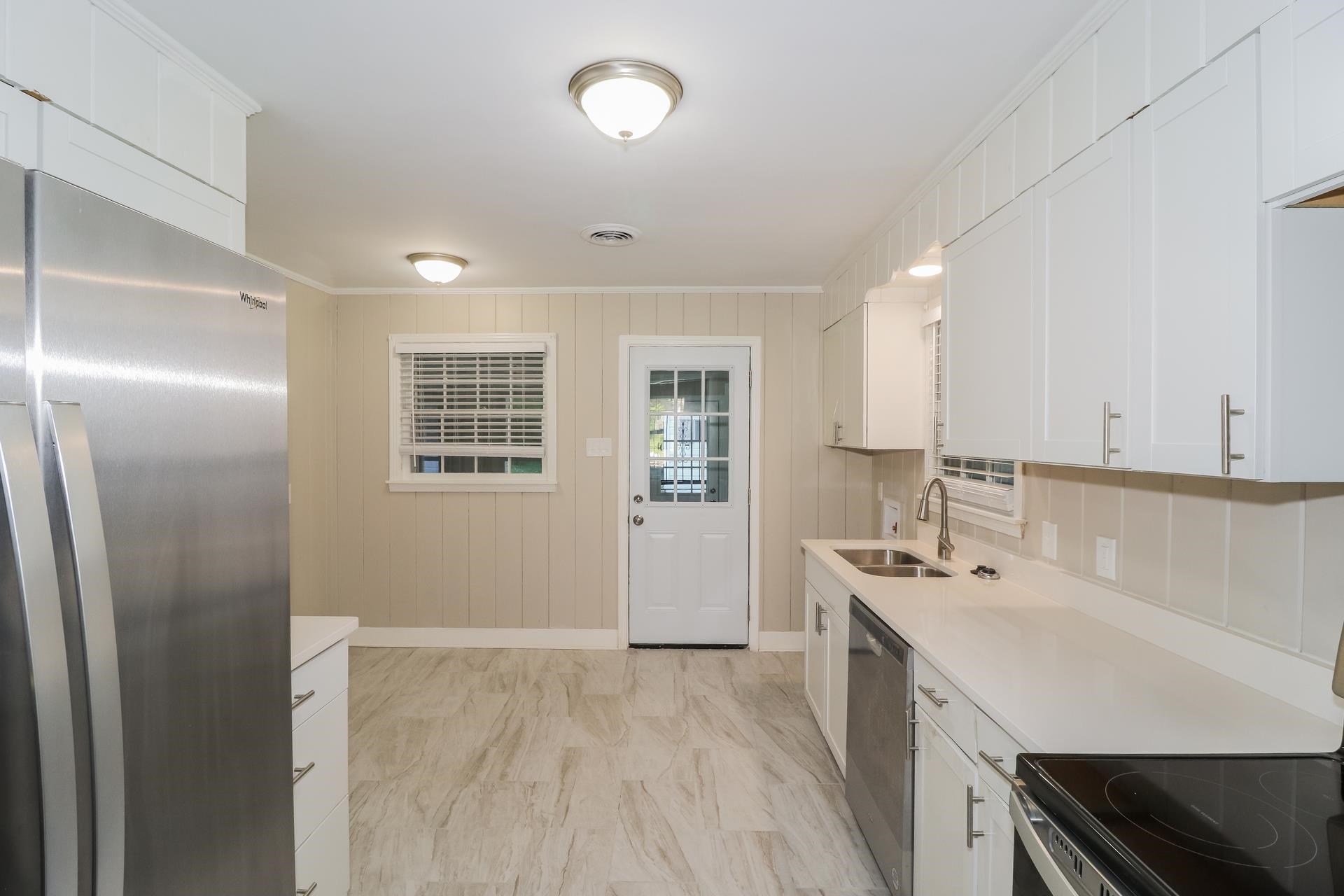 4947 Dee Road Memphis, TN 38117 - Photo 6 of 15 a kitchen with stainless steel appliances a sink stove and refrigerator
