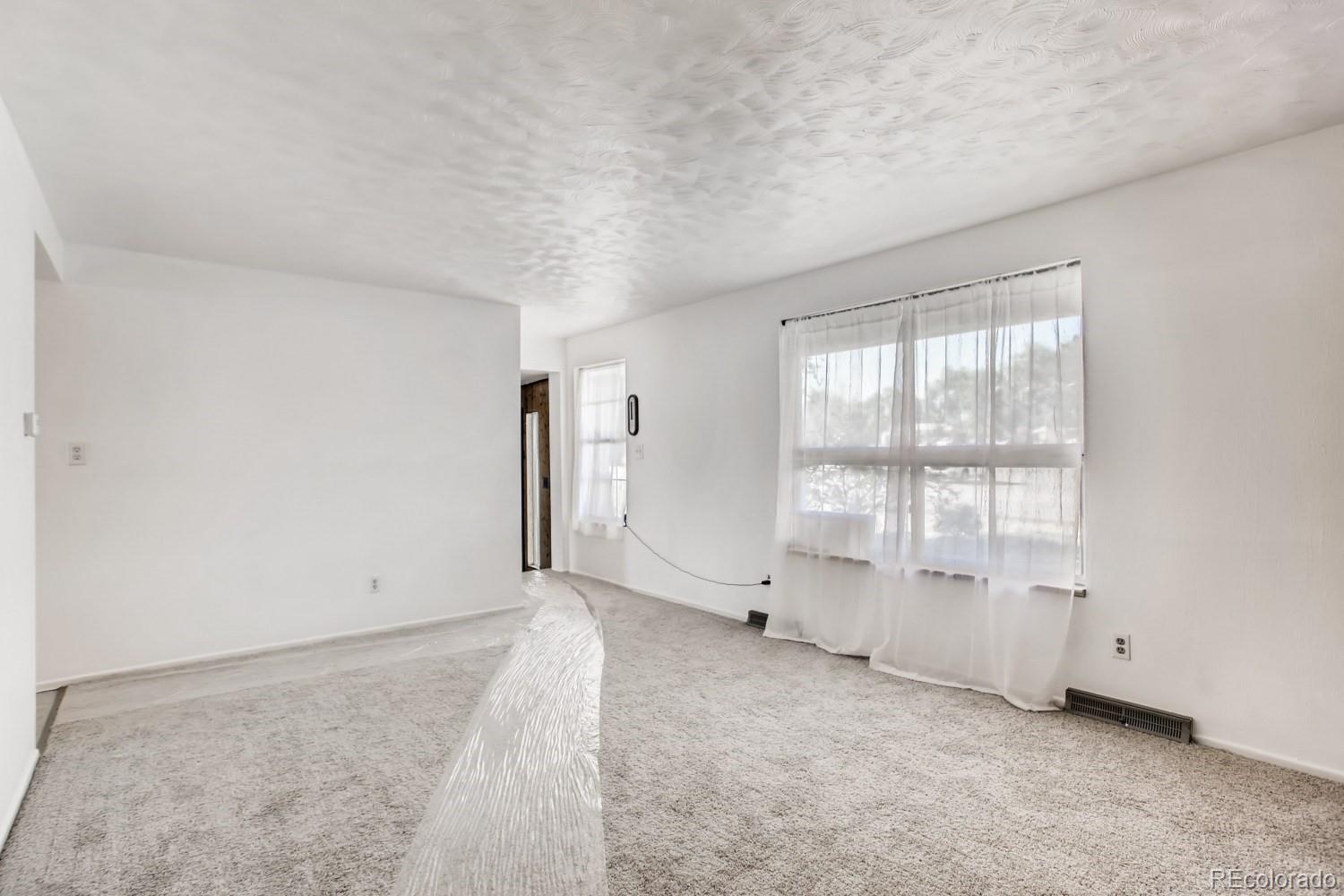 16060 Mt Vernon Road Golden, CO 80401 - Photo 11 of 29 an empty room with windows
