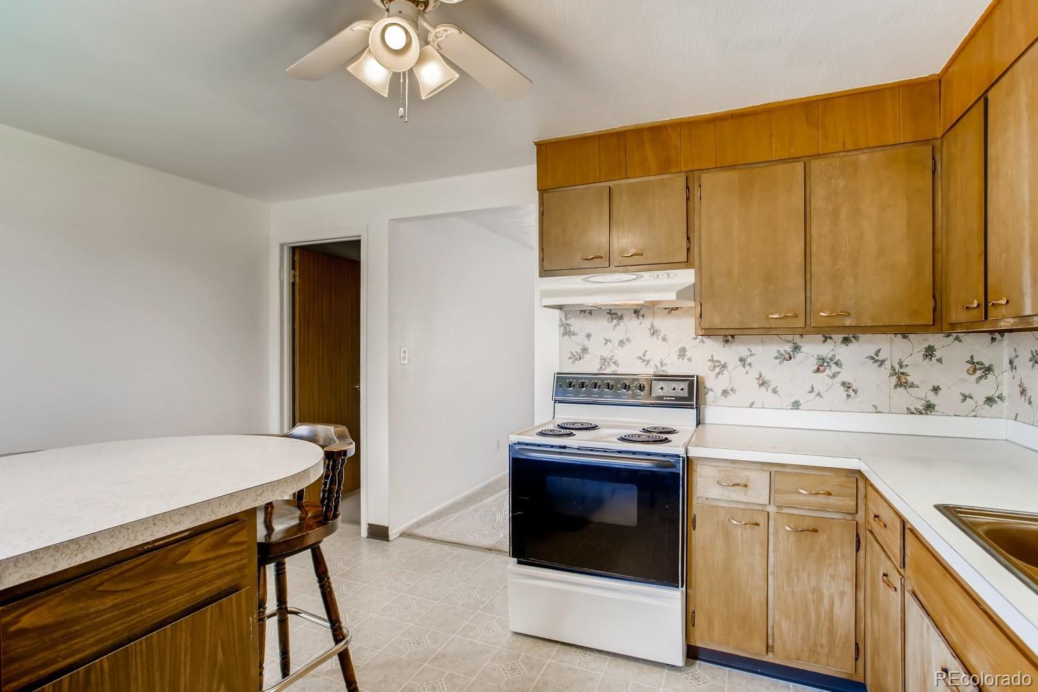 16060 Mt Vernon Road Golden, CO 80401 - Photo 12 of 29 a kitchen with stainless steel appliances a stove a sink and cabinets