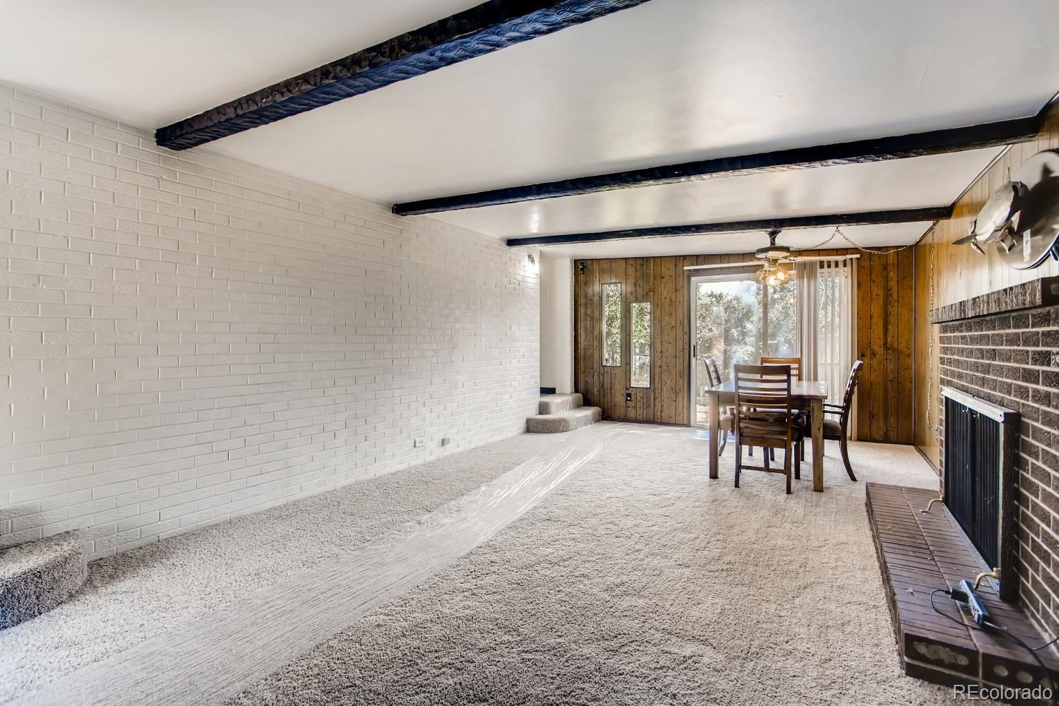 16060 Mt Vernon Road Golden, CO 80401 - Photo 13 of 29 a living room with furniture a fireplace and a flat screen tv