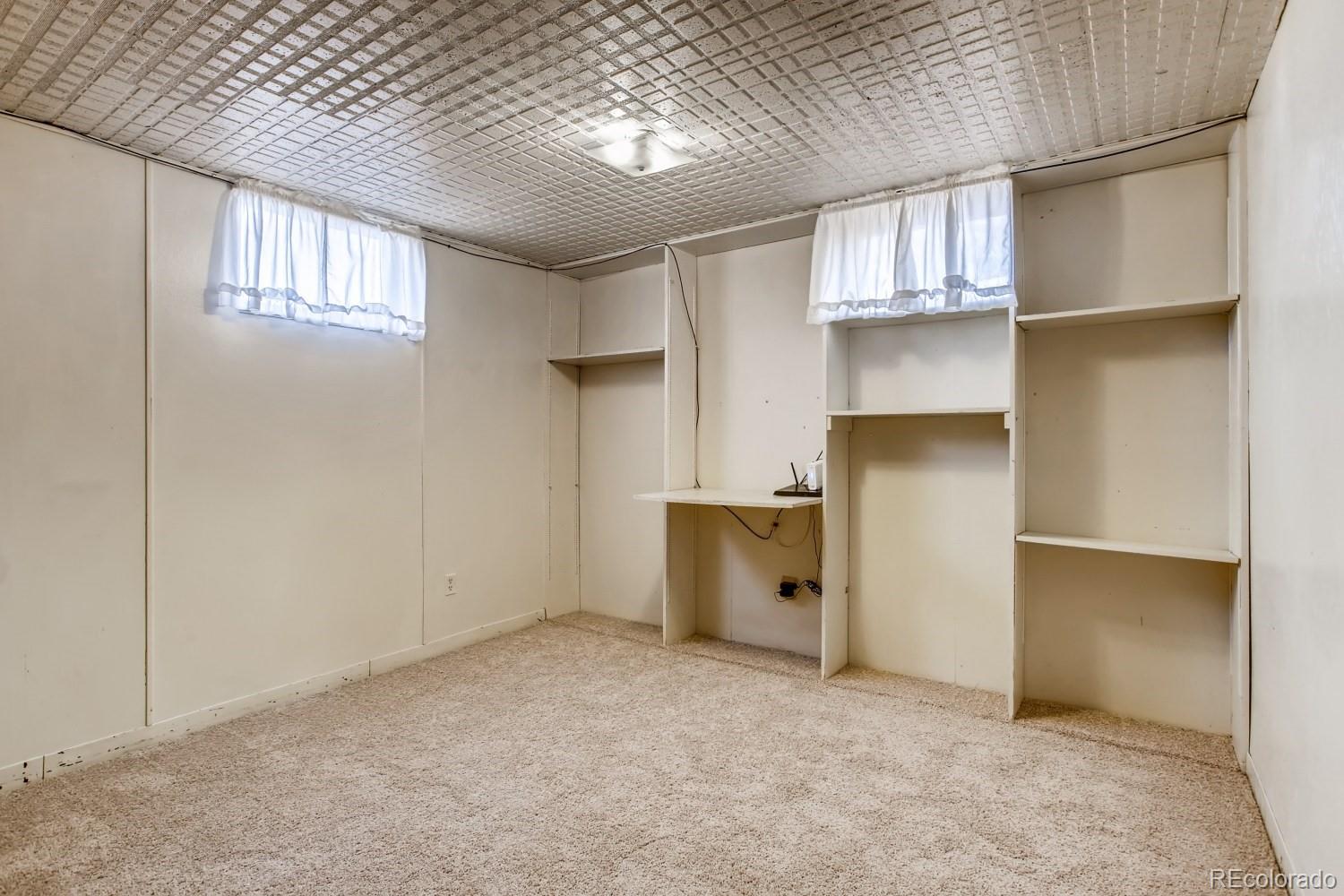 16060 Mt Vernon Road Golden, CO 80401 - Photo 22 of 29 an empty room with windows