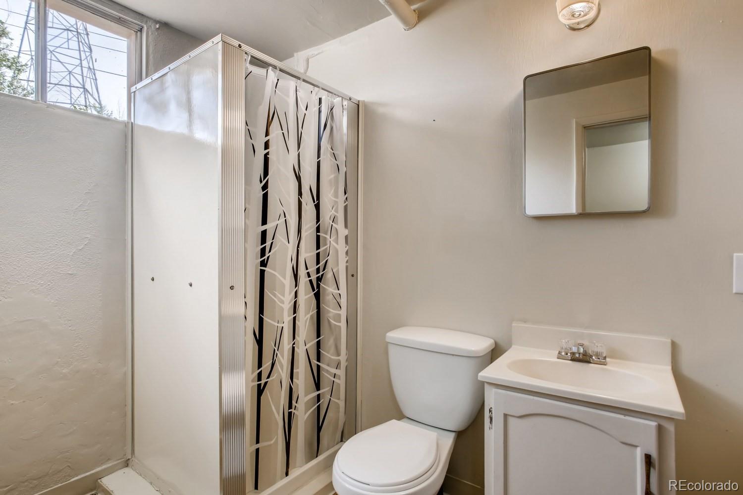 16060 Mt Vernon Road Golden, CO 80401 - Photo 24 of 29 a white toilet sitting next to a bathroom sink