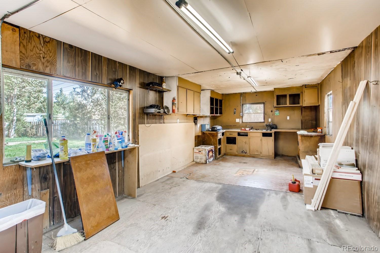 16060 Mt Vernon Road Golden, CO 80401 - Photo 26 of 29 a living room with furniture a flat screen tv and a sink