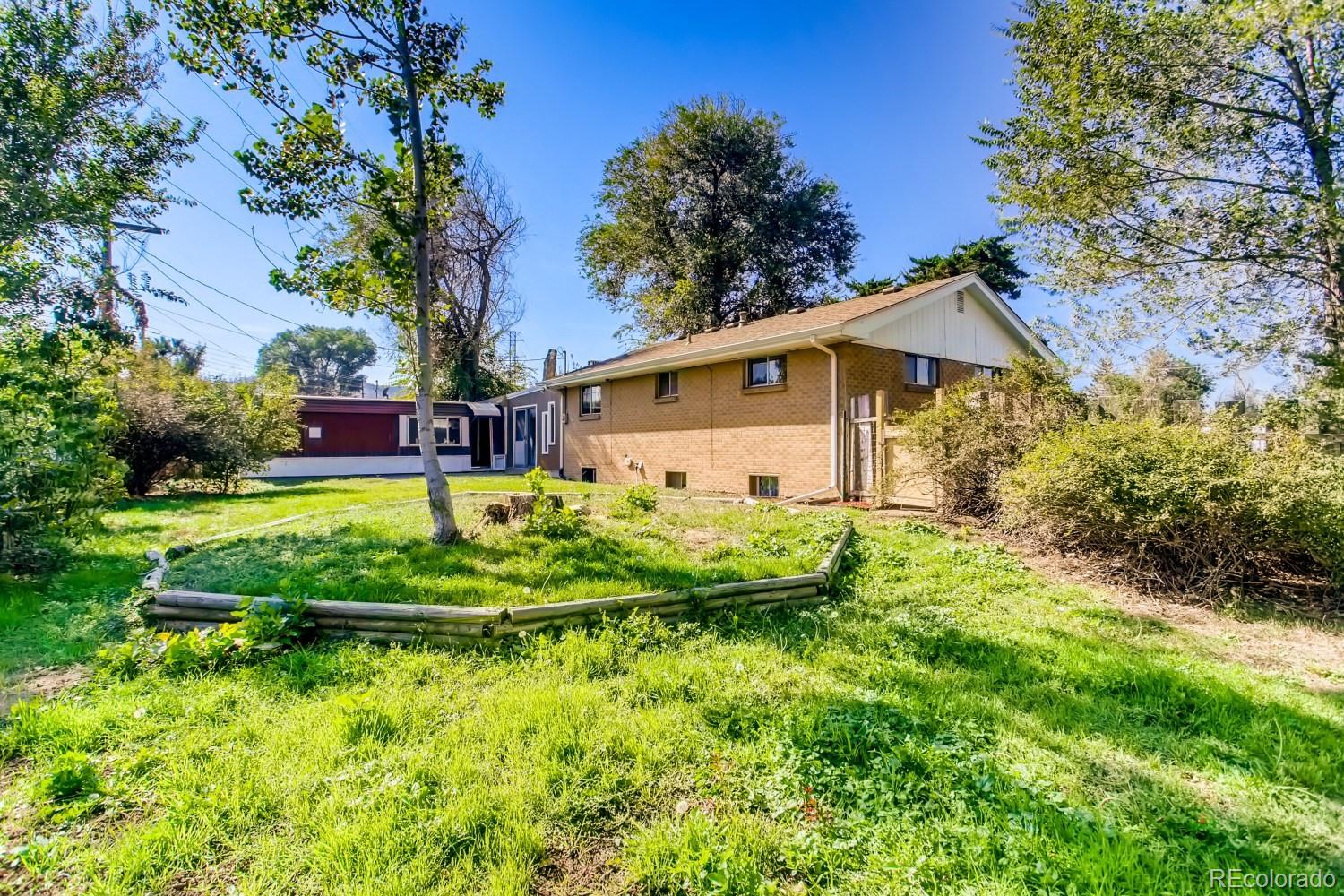 16060 Mt Vernon Road Golden, CO 80401 - Photo 28 of 29 a view of a house with a yard and plants