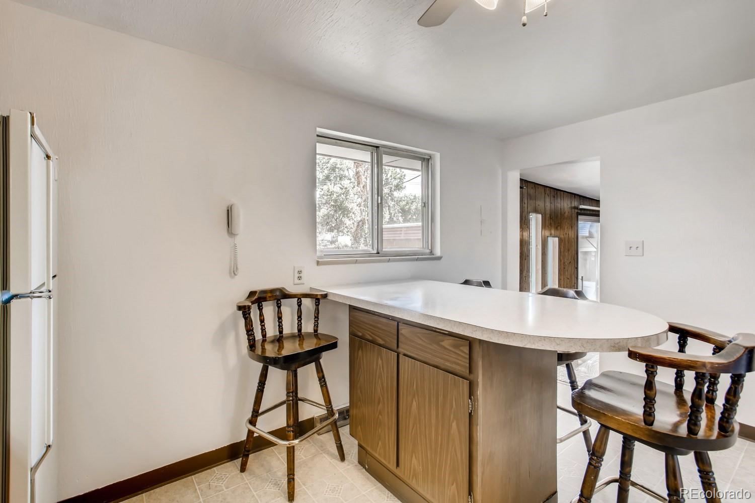 16060 Mt Vernon Road Golden, CO 80401 - Photo 8 of 29 a room with a table chairs and a refrigerator