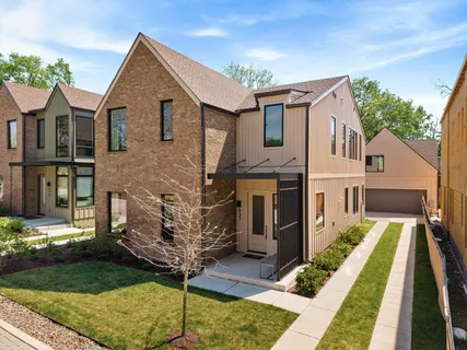 a dining area with a table chairs and a kitchen