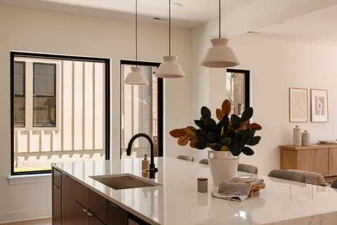 a living room with furniture and large windows