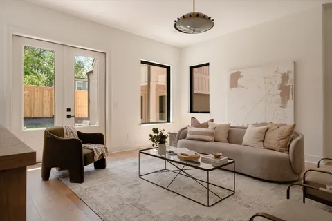 a living room with furniture and a large mirror