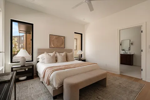 a bathroom with a bathtub sink vanity mirror and toilet