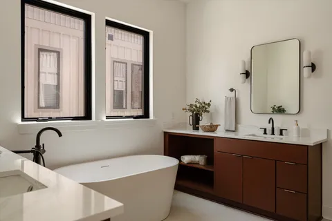 a bathroom with a sink toilet vanity and shower