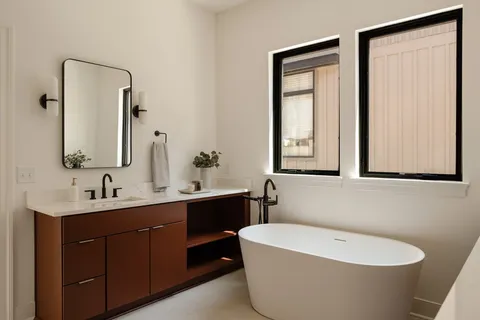 a bathroom with a bathtub sink vanity and toilet