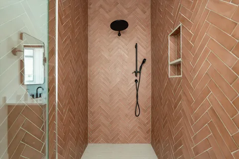 a view of a patio with couple of chairs and a rug