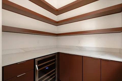 a view of a white house with iron fence