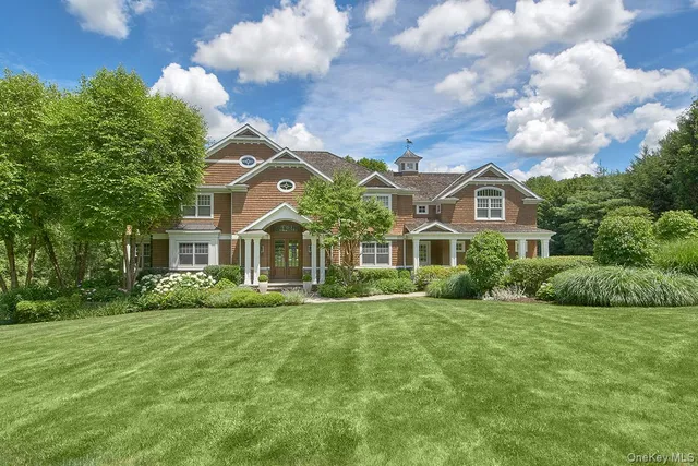 a front view of house with yard and green space