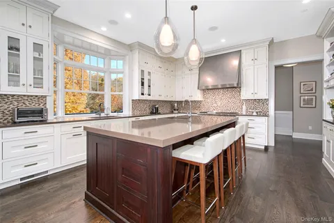 a kitchen with granite countertop a sink a center island and cabinets