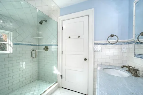 a living room with furniture a fireplace and a large window