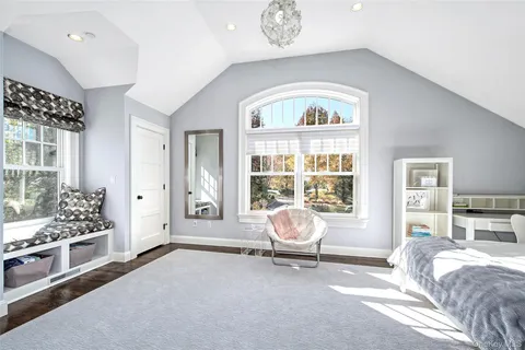 a bedroom with bed and window