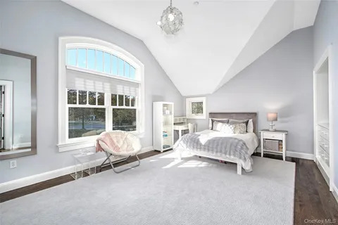 a bathroom with a granite countertop sink toilet a mirror and shower
