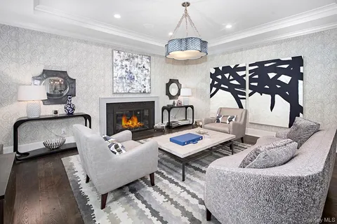 a living room with furniture and a chandelier