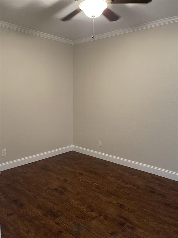 5310 Keller Springs Road, Unit 423 Dallas, TX 75248 - Photo 7 of 7 Unfurnished room with dark wood finished floors, a ceiling fan, and crown molding