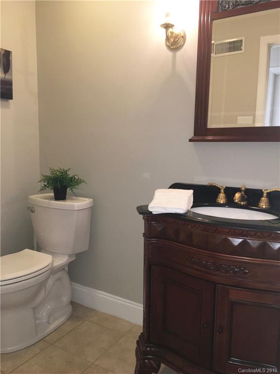 6418 Sardis Road Charlotte, NC 28270 - Photo 18 of 35 a bathroom with a sink a toilet and mirror