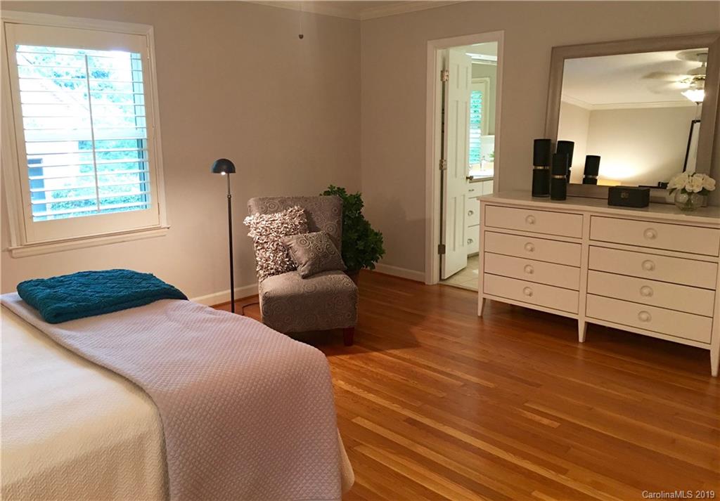6418 Sardis Road Charlotte, NC 28270 - Photo 22 of 35 a bedroom with a bed and a large mirror