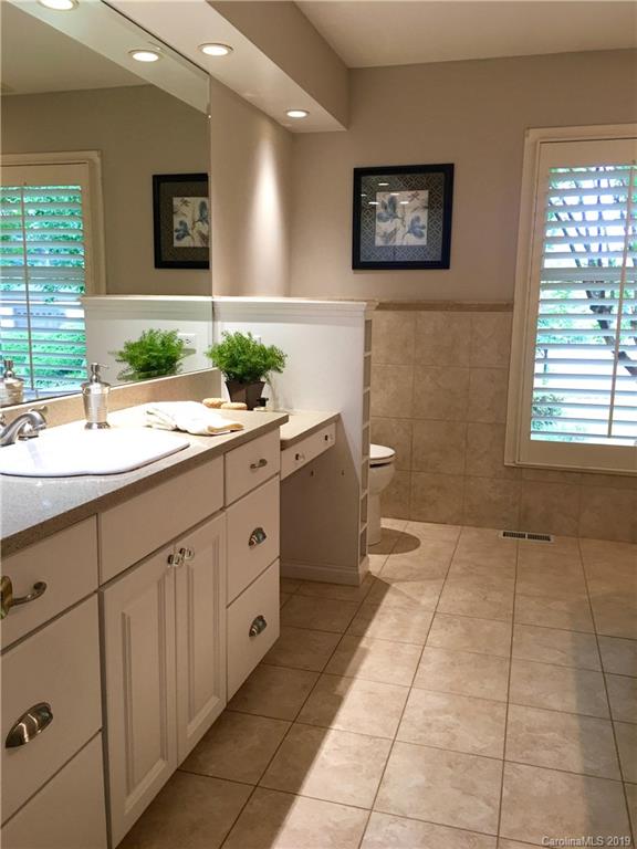 6418 Sardis Road Charlotte, NC 28270 - Photo 25 of 35 a spacious bathroom with a double vanity sink a mirror and a bathtub
