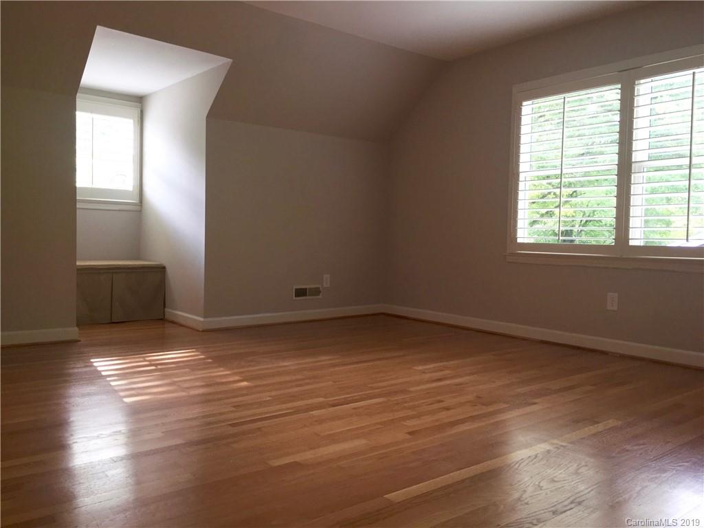 6418 Sardis Road Charlotte, NC 28270 - Photo 31 of 35 an empty room with wooden floor and windows