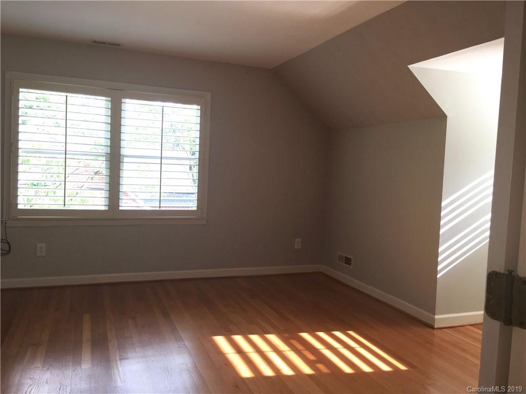 6418 Sardis Road Charlotte, NC 28270 - Photo 32 of 35 a view of an empty room with wooden floor and a window