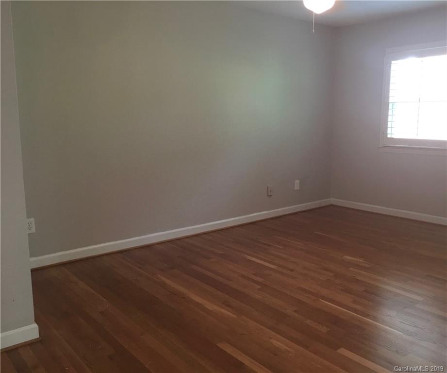 6418 Sardis Road Charlotte, NC 28270 - Photo 33 of 35 an empty room with wooden floor and windows