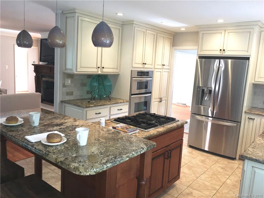 6418 Sardis Road Charlotte, NC 28270 - Photo 10 of 35 a kitchen with stainless steel appliances granite countertop a sink a refrigerator and a stove