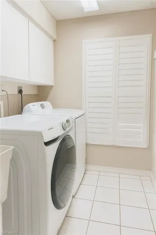 a utility room with a sink dryer and washer