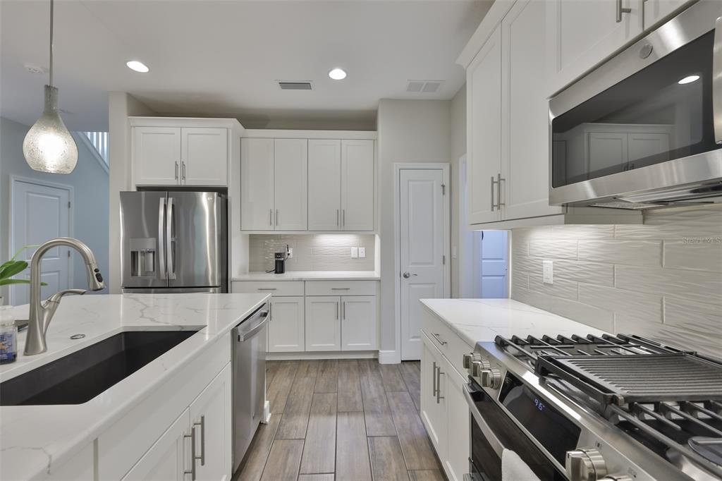 2262 Spring Lake Clearwater, FL 33763 - Photo 15 of 51 a kitchen with stainless steel appliances granite countertop a stove a sink dishwasher and a refrigerator