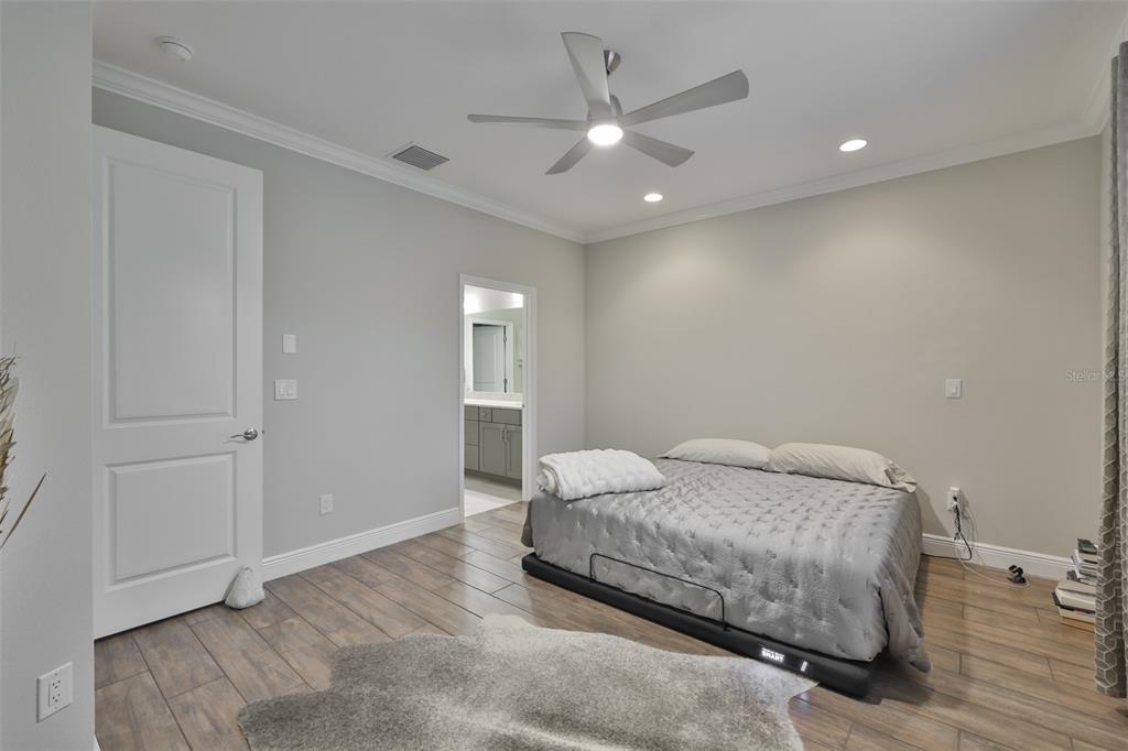 2262 Spring Lake Clearwater, FL 33763 - Photo 18 of 51 a bedroom with a bed and a chandelier