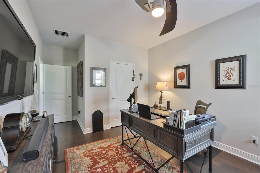 2262 Spring Lake Clearwater, FL 33763 - Photo 30 of 51 a living room with furniture a fireplace and a flat screen tv