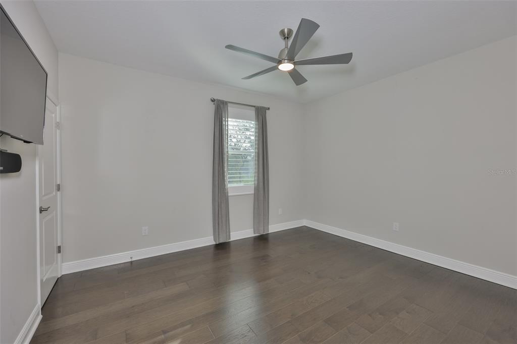 2262 Spring Lake Clearwater, FL 33763 - Photo 36 of 51 an empty room with wooden floor fan and windows