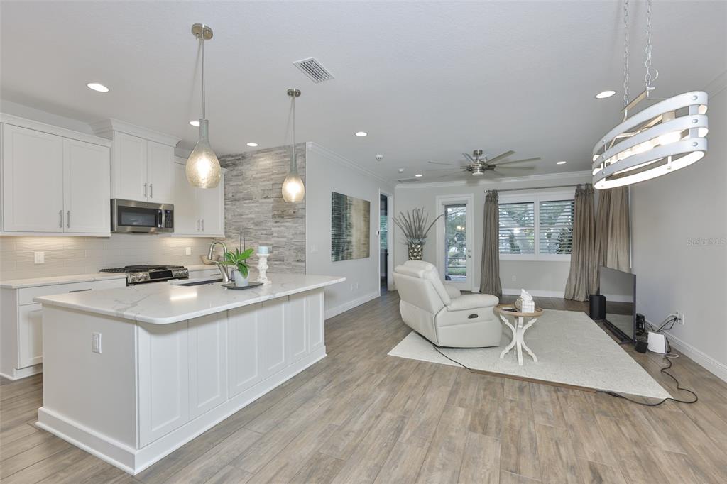 2262 Spring Lake Clearwater, FL 33763 - Photo 5 of 51 a large kitchen with kitchen island a large island a sink stainless steel appliances and cabinets