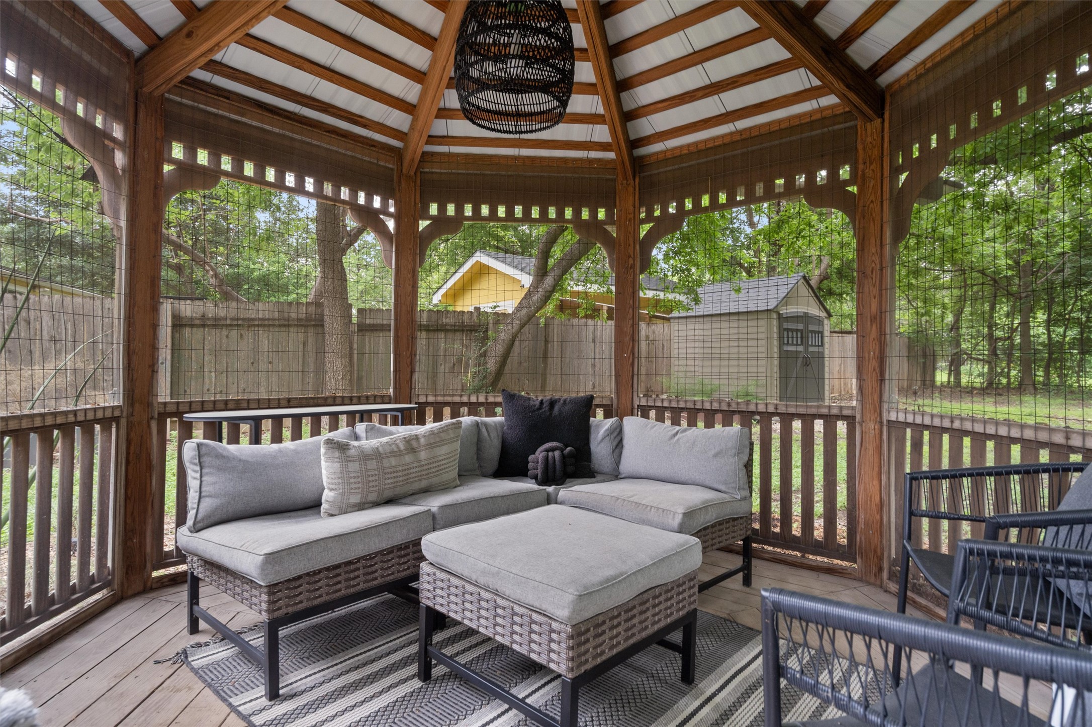 8436 Bangor Bend Austin, TX 78758 - Photo 28 of 29 Inside the gazebo, you get a second outdoor living room with screens, shade, and a full view back across the yard.