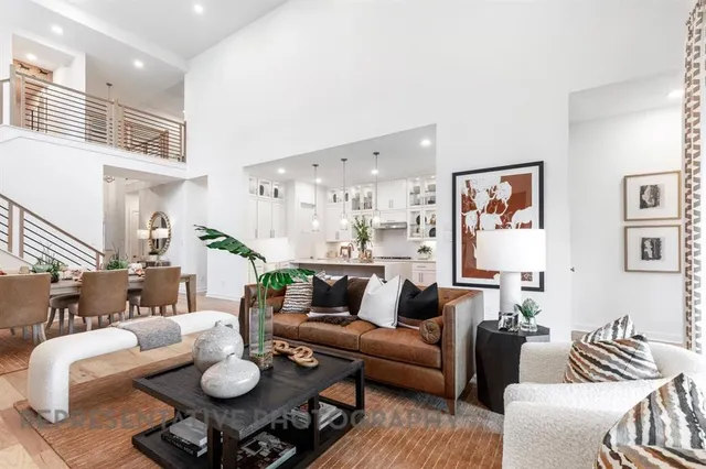 a living room with furniture and a dining table with kitchen view