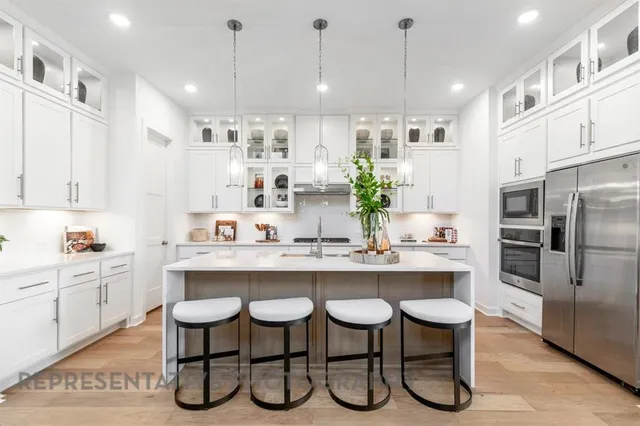 a kitchen with a sink and chairs